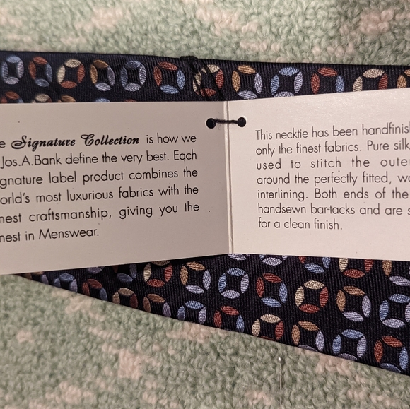 Jos. A. Bank signature collection navy tie with multi color geometric pattern. - Picture 2 of 4